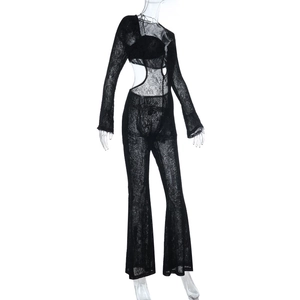 Detailed close-up of black floral lace fabric with sheer cut-out design on jumpsuit
