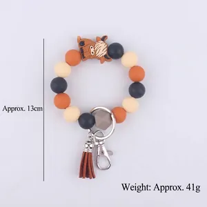 Cartoon cow silicone beaded wristlet keychain with orange tassels and silver carabiner