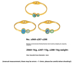 Macro detail of Bohemian titanium steel gold bangles with turquoise and evil eye inlays