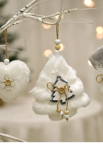 Detail of plush heart and tree Christmas hanging ornaments with wooden beads on rope