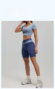 Detail view of high-waist biker shorts with cross-over waistband and two-tone fabric