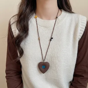 Ethnic pearl necklace with heart pendant and multicolor stone beads on model