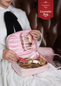 Pink velvet makeup bag with gold stars and specialized makeup brush compartment