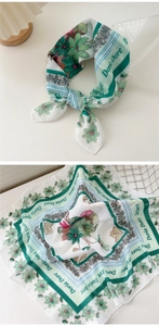 Detail of floral green cotton linen scarf showing knot style and print texture