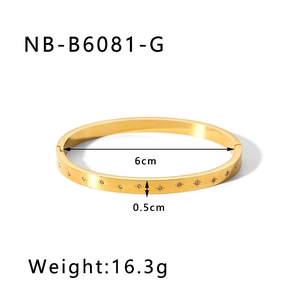 Detail showing gold starburst engraving and cubic zirconia stones on titanium steel bangle
