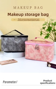 Detail of grey and pink crocodile texture makeup bags with sturdy top handles and dual zippers