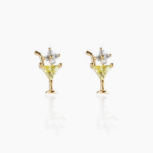 Macro shot of 18K gold cocktail glass earrings with yellow zircon and gold straw detail