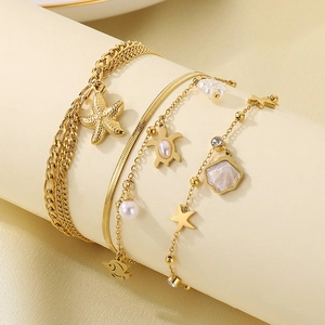 Double-layered golden stainless steel anklet with starfish, turtle and shell charms