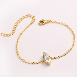Golden chain bracelet featuring two heart-shaped birthstones with lobster clasp closure