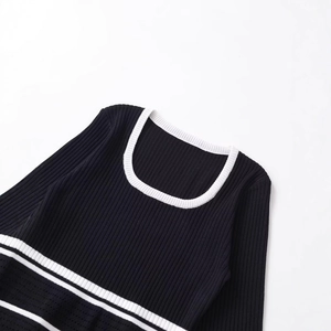 Women's black ribbed knit top featuring a white U-neckline and horizontal striped details