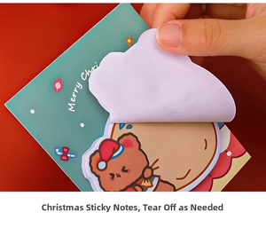 Macro shot of hand peeling a purple cloud-shaped Christmas sticky note with a cute bear