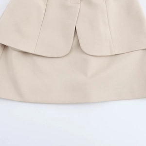 Close-up of the beige sleeveless dress hemline with high-quality smooth cotton fabric