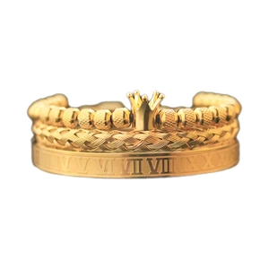 Detailed close-up of three-piece gold vintage bracelet set with crown and Roman numerals