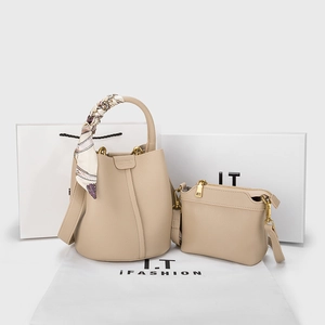 Detail of beige lychee leather bucket bag with silk scarf and matching inner pouch