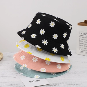 Women's reversible daisy floral bucket hats in black, white, pink and green colors