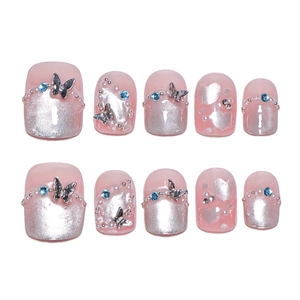 Pink cat-eye press-on nails with 3D silver butterflies, blue rhinestones, and pearls