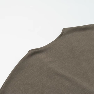 Detail of olive green midi dress featuring a classic crew neck and premium knit texture