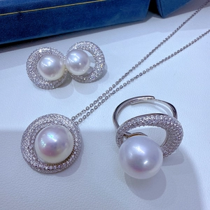 Macro shot of S925 silver pearl jewelry set with necklace, ring and stud earrings
