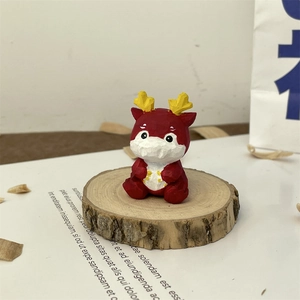 Macro shot of a red hand-carved dragon zodiac figurine on a wooden base