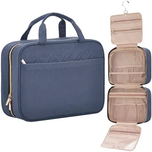 Detail of blue quilted hanging toiletry bag showing internal compartments and metal hook