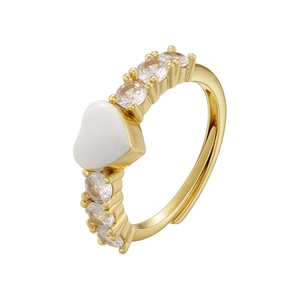 Detail of adjustable gold ring with white enamel heart and micro-paved cubic zirconia