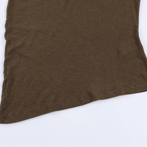Detailed view of dark brown knitted top with asymmetrical curved hem and slub texture