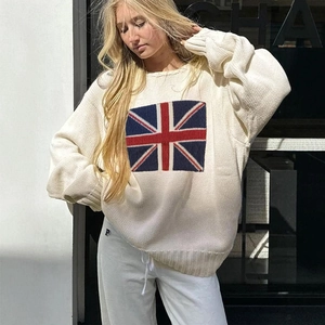 Close-up of the knitted Union Jack flag pattern on a cream oversized crewneck sweater