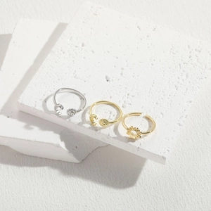 Minimalist open sun and moon rings in gold and silver finish on stone display