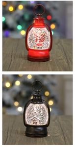 Detail of Christmas water lanterns featuring Santa Claus and winter cabin with LED glitter