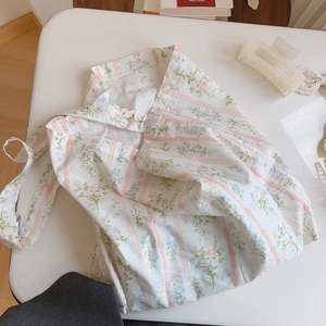 Detailed view of floral pattern and pink stripes on cotton tote bag with handle