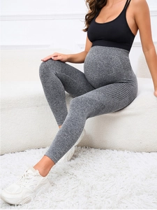 Detail of grey maternity yoga leggings showing high waist belly support and seamless fabric