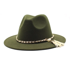 Detail of dark green wool fedora hat featuring gold chain and pearl tassel decoration