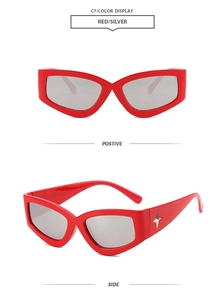 Detail view of red cat-eye sunglasses with silver lenses and star metal accents