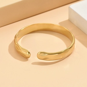 Baroque style gold-plated stainless steel cuff bracelet with irregular hammered texture