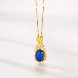 Golden teardrop necklace with color-changing blue stone and zircon halo setting