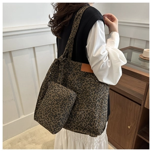 Detail view of leopard print canvas tote bag with a matching small accessory pouch