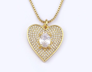 Close-up of gold-plated heart pendant necklace with shimmering zircon pavé and center stone