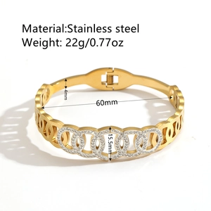 Gold stainless steel open bangle with cross gradient pattern and sparkling rhinestones