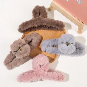 Close-up of plush faux fur hair claw clips in brown, coffee, gray and pink colors
