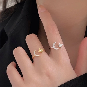 Close-up of adjustable moon and star rings with inlaid zircon on model's hand