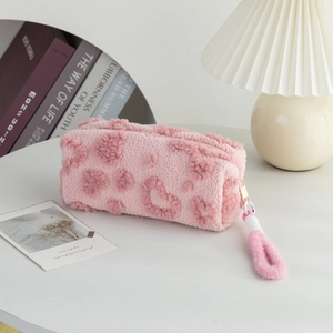 Close-up of pink fuzzy pencil case showing soft plush fabric and cute heart pattern