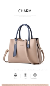 Detail of lychee pattern faux leather on apricot handbag with dark blue top handle