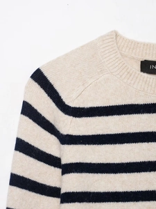 Detail of the ribbed crew neck and navy stripes on this soft knit beige sweater