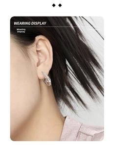 Detail of S925 sterling silver U-shaped earring with geometric cutouts and micro zircon