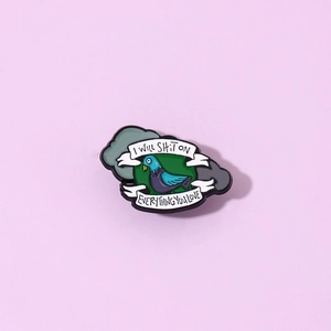 Detail of funny enamel pigeon pin featuring I Will Shit On Everything You Love quote