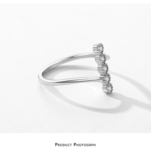Macro view of five round cubic zirconia stones set in an irregular S925 silver ring band