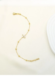 Detail showing gold titanium steel bracelet with marquise zircon flower and tiny metal beads