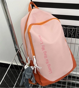 Pink and orange patchwork backpack in metal basket with a cute frog plush pendant