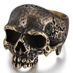 Detailed view of vintage bronze skull ring with gothic cracked textures on white background