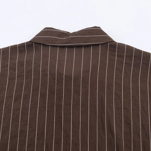 Détail d'une chemise en popeline à rayures brunes montrant l'empiècement et le col